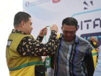 Sumber Foto : Humas Pemkot, Wali Kota Makassar Munafri Arifuddin mengenakan rompi dan memasangkan kalung identitas QRIS kepada perwakilan juru parkir saat peluncuran program Digitalisasi Parkir di Jl. WR Supratman, Makassar, Senin (1/9/2025).